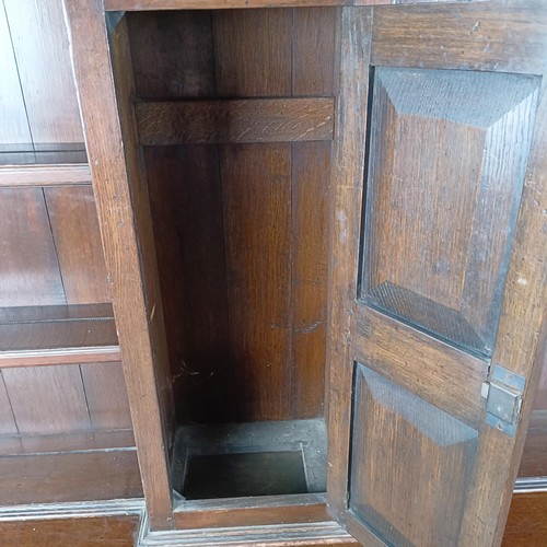 47 - An 18th century style oak dresser, the back fitted an 8 day clock (not shown), the base with three d... 