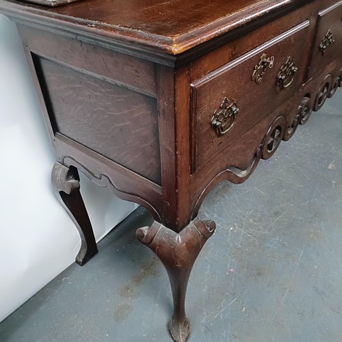 47 - An 18th century style oak dresser, the back fitted an 8 day clock (not shown), the base with three d... 