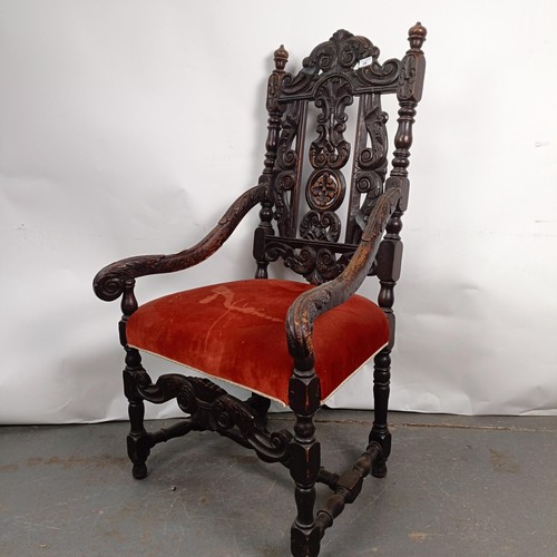 49 - An 19th century style oak armchair, with a carved back