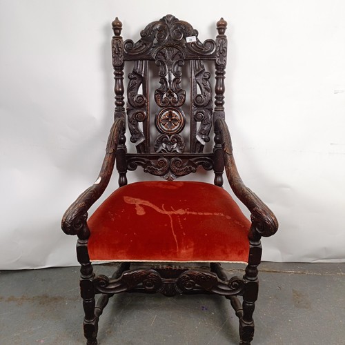 49 - An 19th century style oak armchair, with a carved back