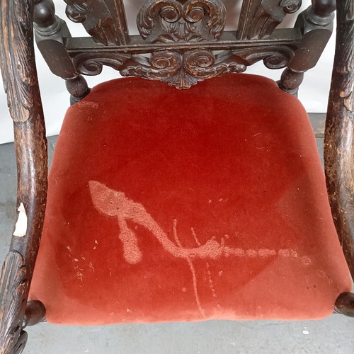 49 - An 19th century style oak armchair, with a carved back