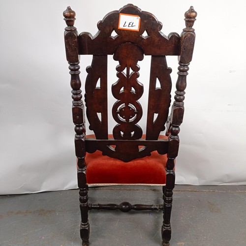 49 - An 19th century style oak armchair, with a carved back