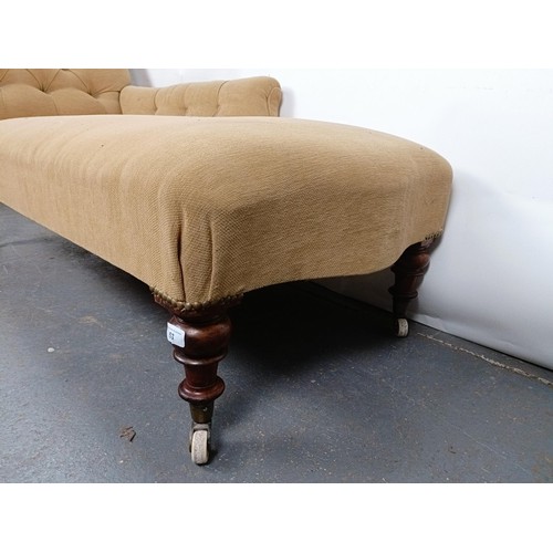 53 - A 19th century button back chaise longue, with mahogany legs to castors, 180 cm wide