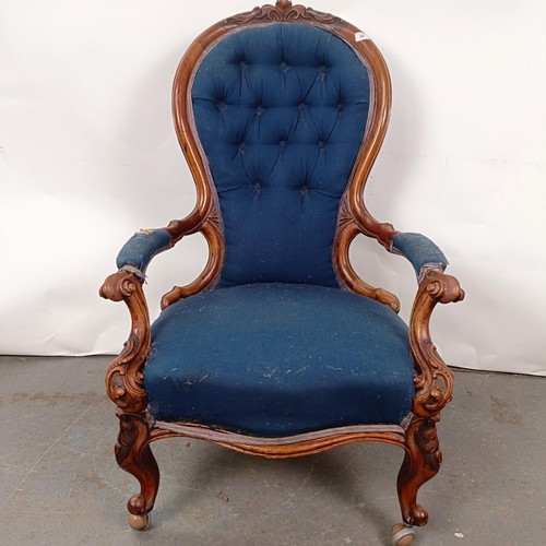 58 - A Victorian walnut framed button back armchair