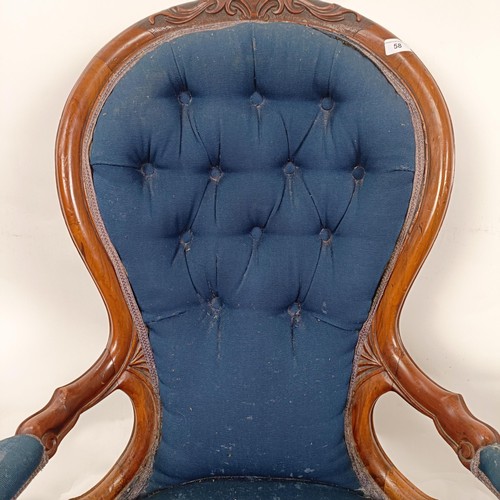 58 - A Victorian walnut framed button back armchair