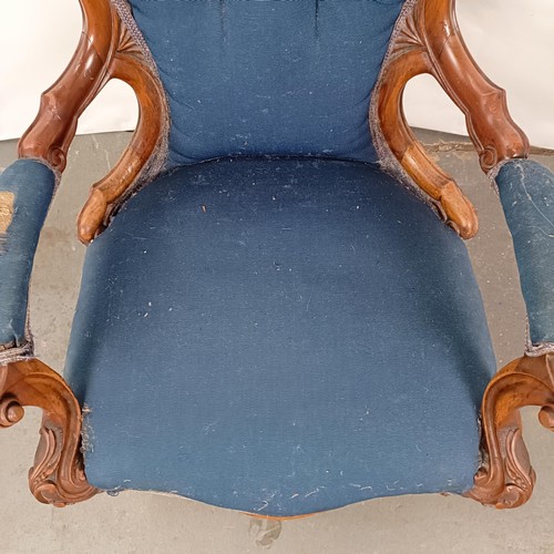 58 - A Victorian walnut framed button back armchair