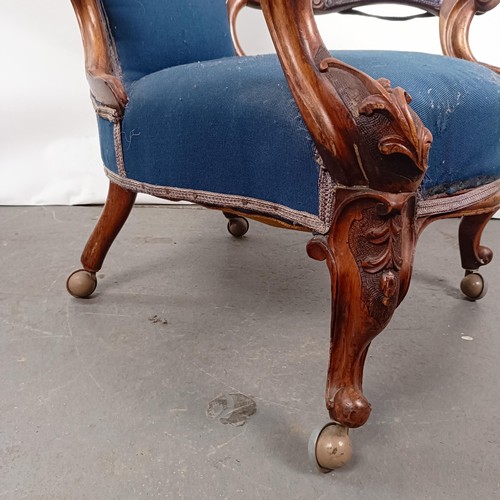 58 - A Victorian walnut framed button back armchair