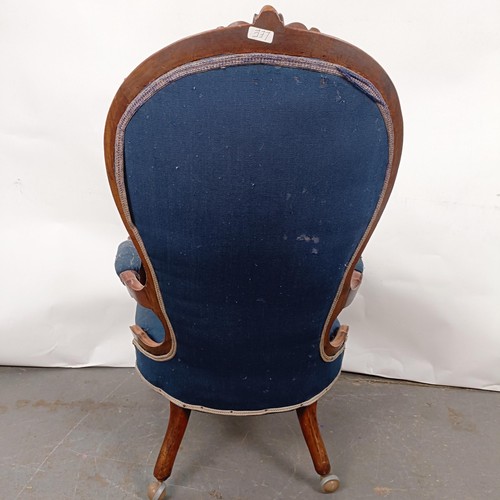 58 - A Victorian walnut framed button back armchair