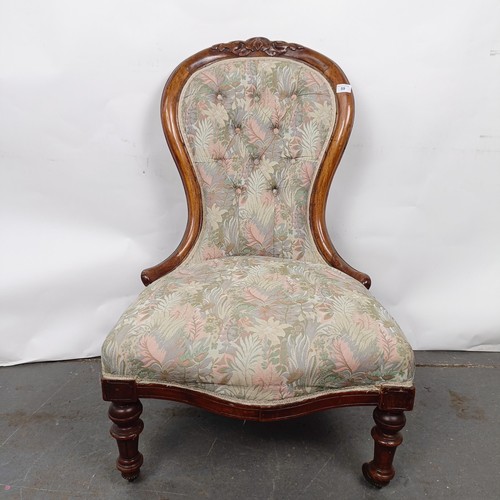 59 - A Victorian walnut framed button back nursing chair