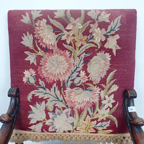 60 - An 19th century oak framed armchair, with a tapestry padded back