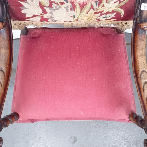 60 - An 19th century oak framed armchair, with a tapestry padded back