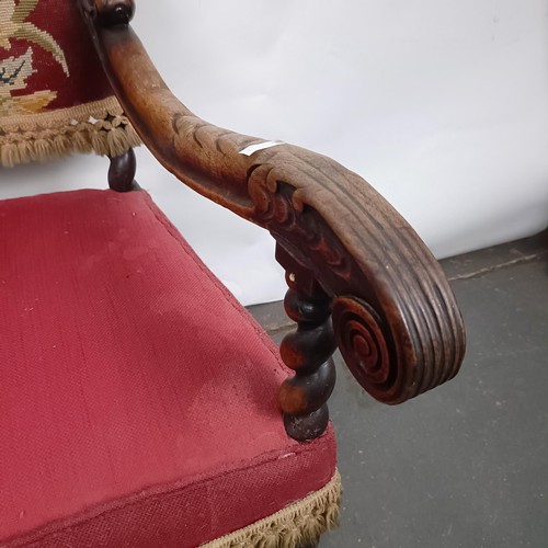 60 - An 19th century oak framed armchair, with a tapestry padded back