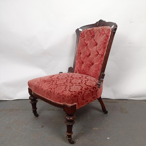 61 - A late 19th century walnut framed button back nursing chair