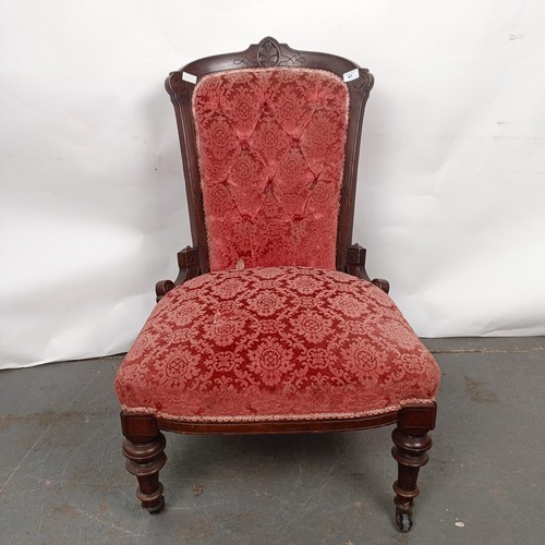 61 - A late 19th century walnut framed button back nursing chair