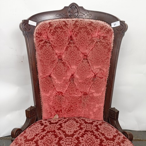 61 - A late 19th century walnut framed button back nursing chair