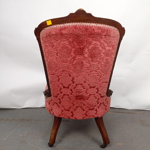 61 - A late 19th century walnut framed button back nursing chair