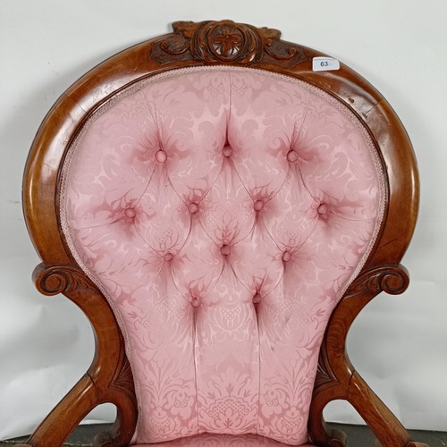 63 - A 19th century walnut framed button back armchair