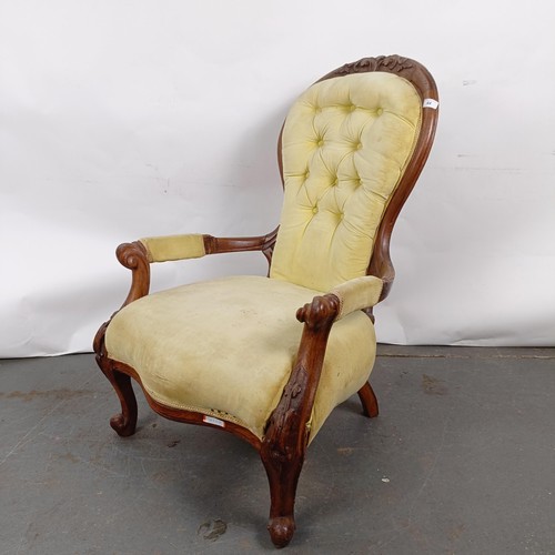 64 - A 19th century walnut framed button back armchair