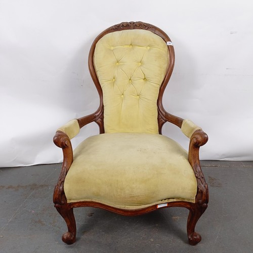 64 - A 19th century walnut framed button back armchair