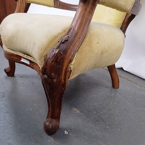 64 - A 19th century walnut framed button back armchair