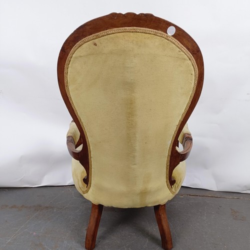 64 - A 19th century walnut framed button back armchair