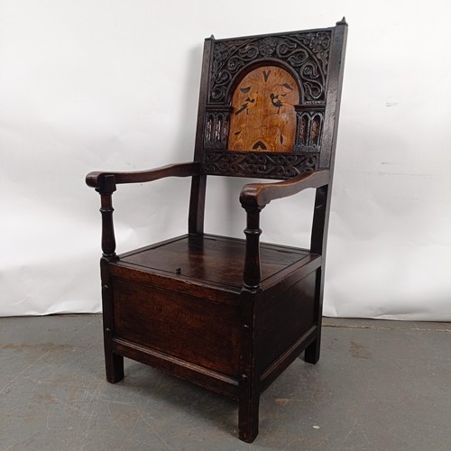 74 - An oak Wainscot type armchair, with a marquetry inlaid panel back