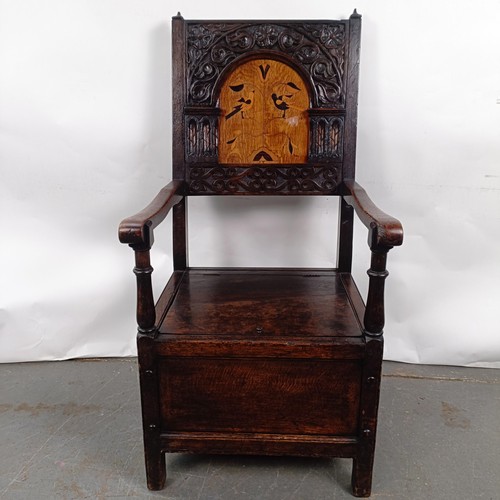 74 - An oak Wainscot type armchair, with a marquetry inlaid panel back