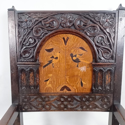 74 - An oak Wainscot type armchair, with a marquetry inlaid panel back