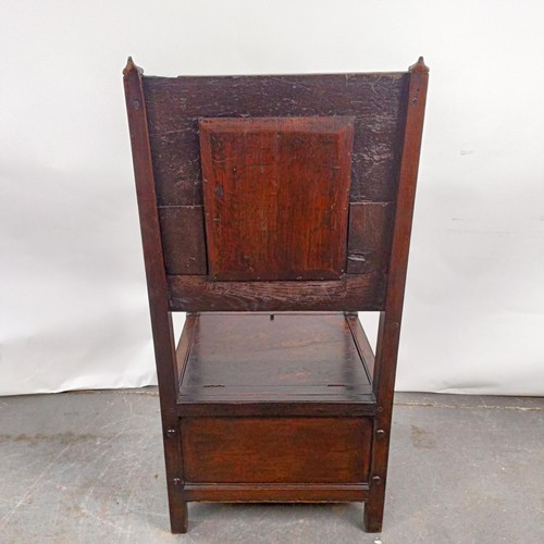 74 - An oak Wainscot type armchair, with a marquetry inlaid panel back