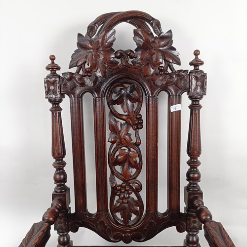 75 - An 18th century style oak armchair, with a carved back