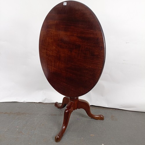 92 - A Victorian mahogany tilt top table, on a column support to a tripod base, 86 cm diameter