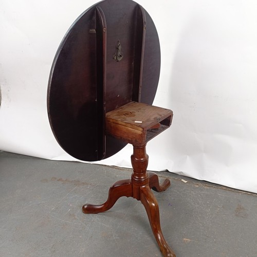 92 - A Victorian mahogany tilt top table, on a column support to a tripod base, 86 cm diameter