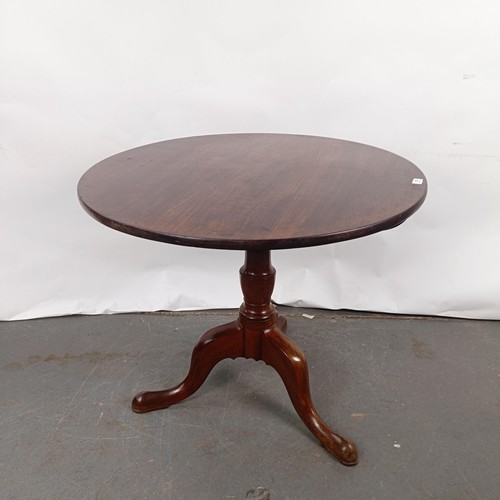 92 - A Victorian mahogany tilt top table, on a column support to a tripod base, 86 cm diameter