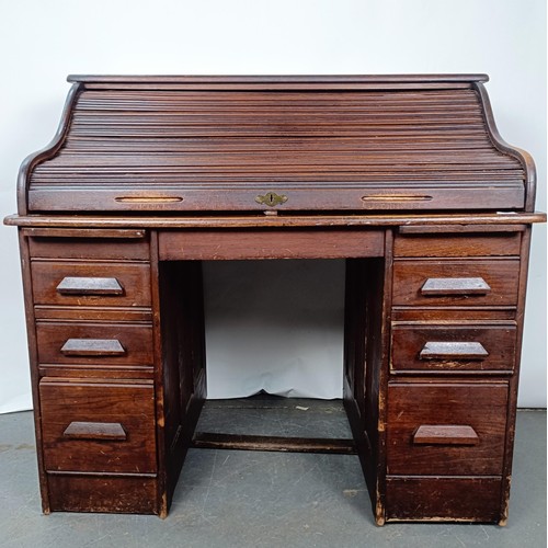 93 - An Edwardian oak roll top desk, 127 cm wide