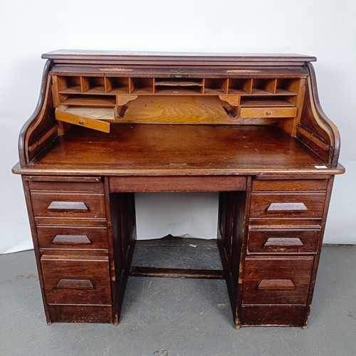 93 - An Edwardian oak roll top desk, 127 cm wide