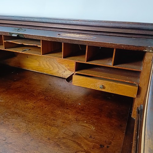 93 - An Edwardian oak roll top desk, 127 cm wide