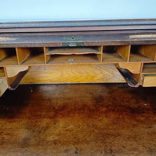 93 - An Edwardian oak roll top desk, 127 cm wide