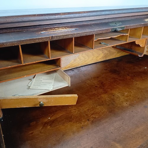 93 - An Edwardian oak roll top desk, 127 cm wide