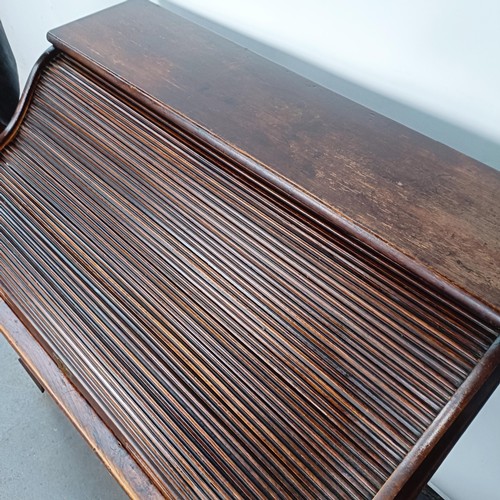 93 - An Edwardian oak roll top desk, 127 cm wide