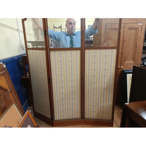 1015 - A late 19th century satinwood framed three fold screen, inset with bevelled glass panels, and floral... 