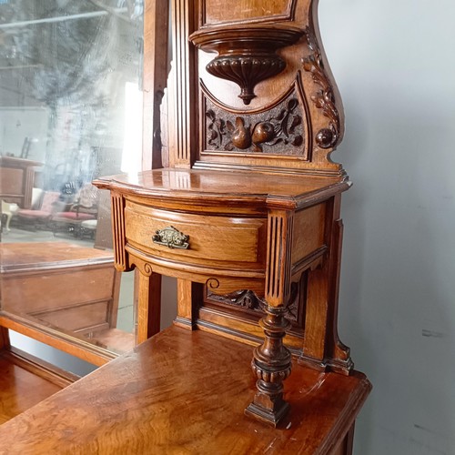 96 - A 19th century walnut kneehole dressing table, superstructure carved shell, fruit and dragons, on a ... 