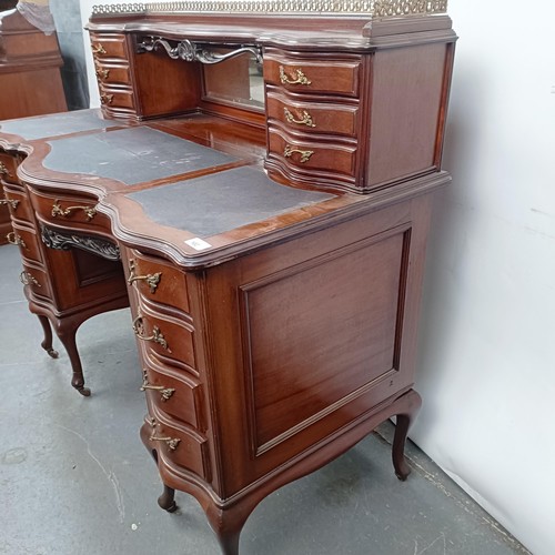 102 - A late 19th/early 20th century walnut writing desk, having eight drawers, and a central faux drawer,... 