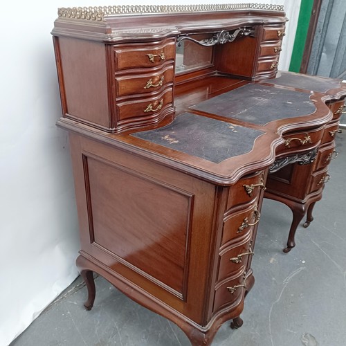 102 - A late 19th/early 20th century walnut writing desk, having eight drawers, and a central faux drawer,... 