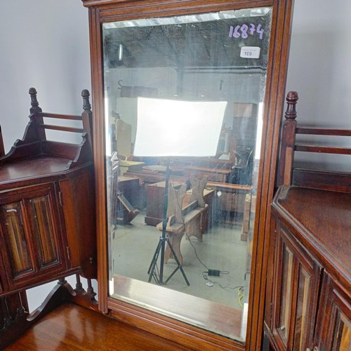 109 - An early 20th century walnut dressing table, flanked by two full length mirrors, 170 cm high x 106 c... 