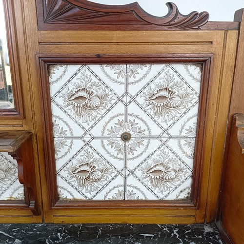 110 - An early 20th century walnut washstand, with a raised tile and mirrored back, on a base with a marbl... 