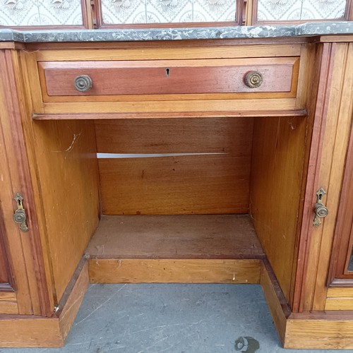 110 - An early 20th century walnut washstand, with a raised tile and mirrored back, on a base with a marbl... 