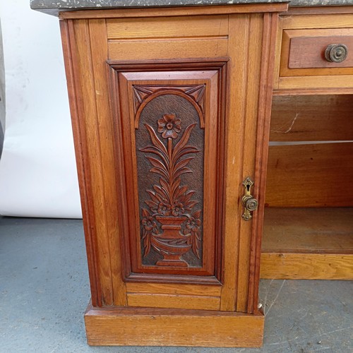 110 - An early 20th century walnut washstand, with a raised tile and mirrored back, on a base with a marbl... 