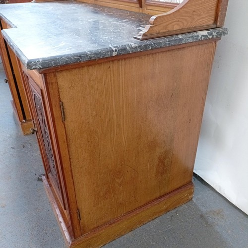 110 - An early 20th century walnut washstand, with a raised tile and mirrored back, on a base with a marbl... 