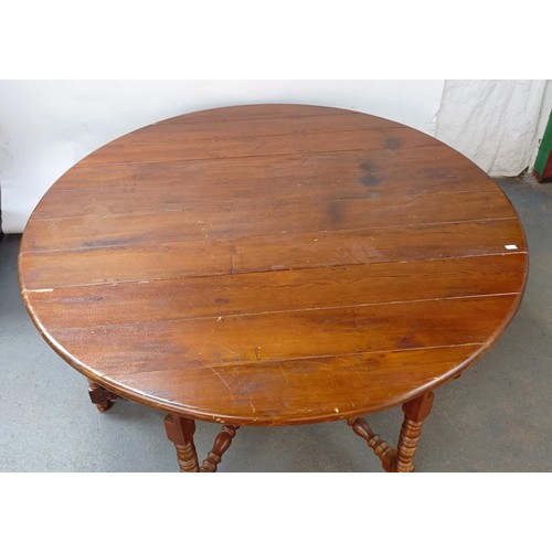 115 - An 18th century style oak gateleg dining table, on bobbin turned legs, 203 cm wide