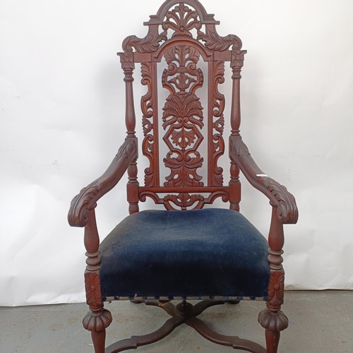 124 - A late 19th century oak armchair, with carved back, 130 cm high